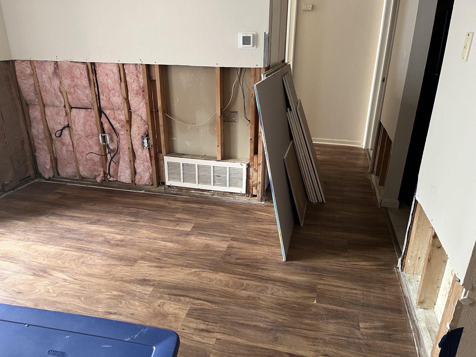 Wall opened after water damage, studs and insulation exposed